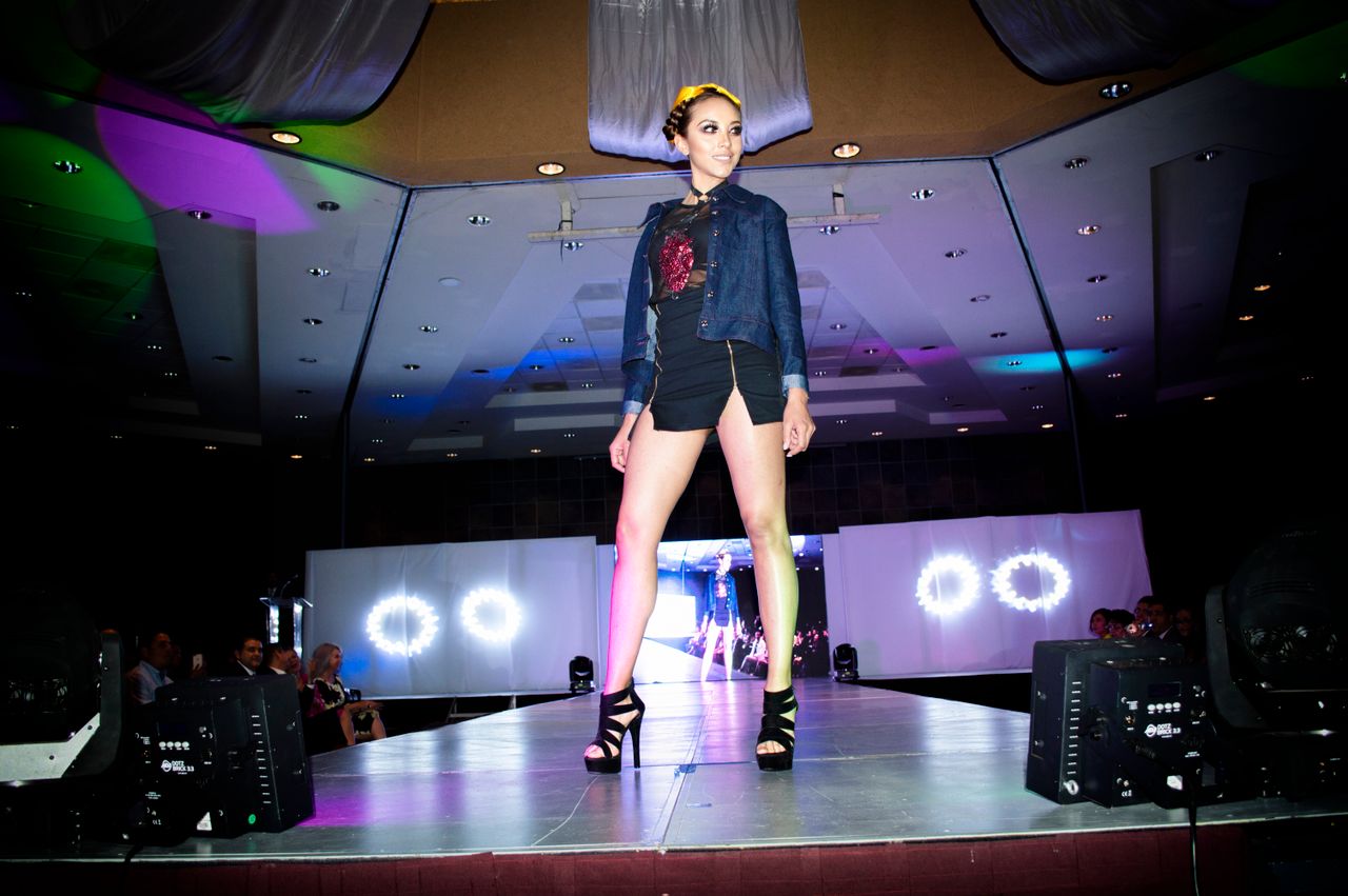 Fashion model showcasing latest trends on a vibrant runway in Morelia, Mexico.